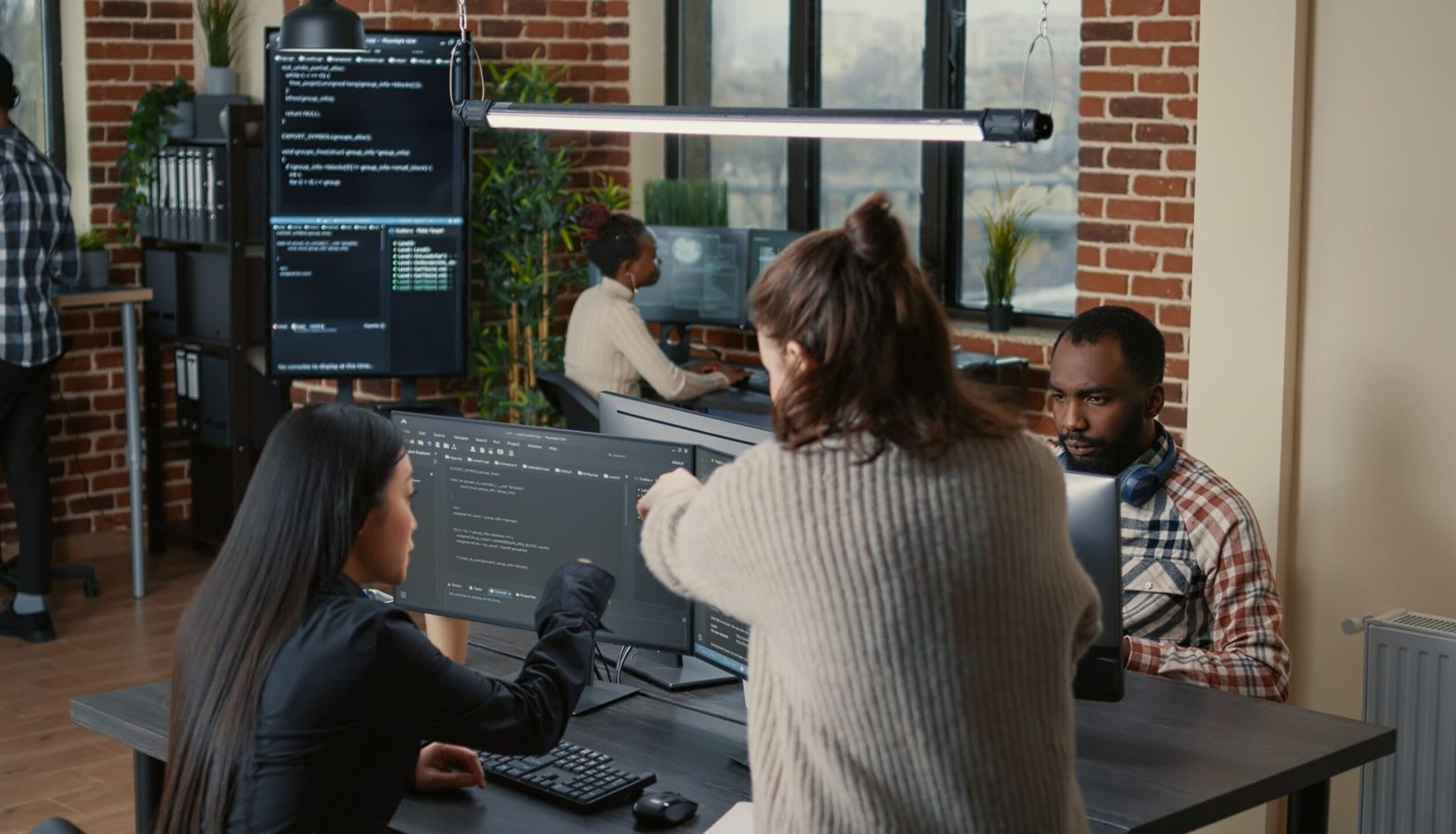 software-programer-pointing-pencil-source-code-computer-screen-explaining-algorithm-coworker-standing-desk-programmers-discussing-online-cloud-computing-with-team (1)